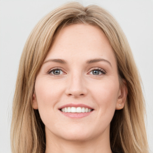 Joyful white young-adult female with long  brown hair and green eyes