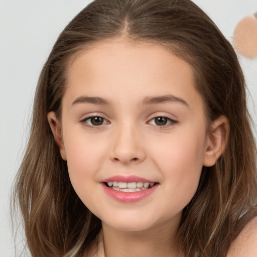 Joyful white child female with long  brown hair and brown eyes