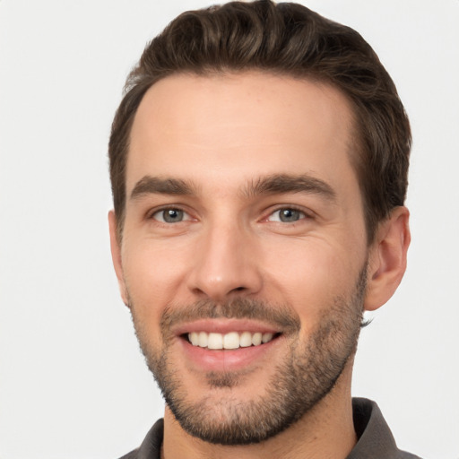 Joyful white young-adult male with short  brown hair and brown eyes