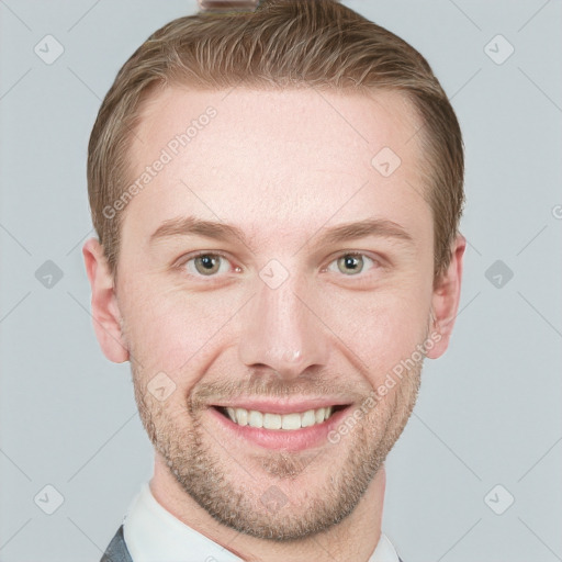 Joyful white adult male with short  brown hair and blue eyes