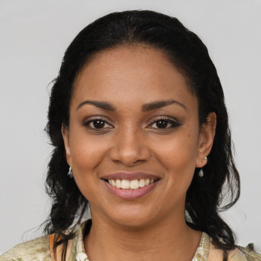 Joyful black young-adult female with medium  black hair and brown eyes