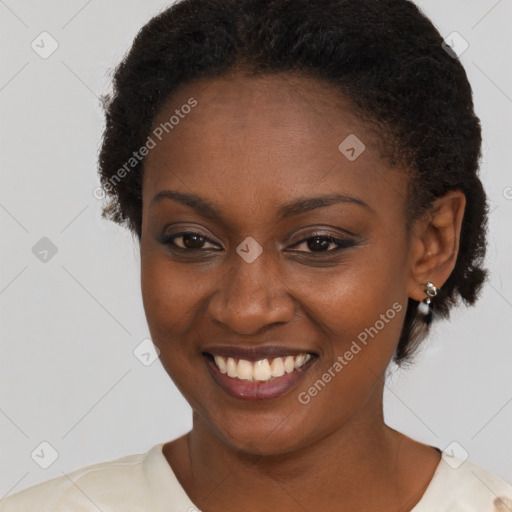 Joyful black young-adult female with short  brown hair and brown eyes