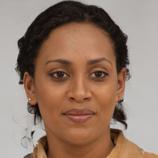 Joyful latino adult female with medium  brown hair and brown eyes