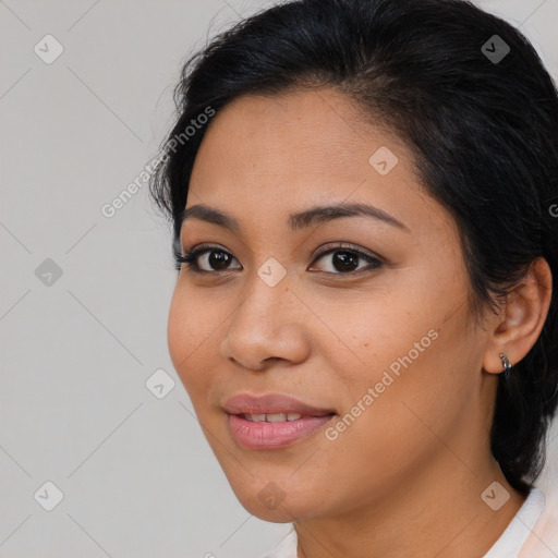 Joyful latino young-adult female with medium  brown hair and brown eyes