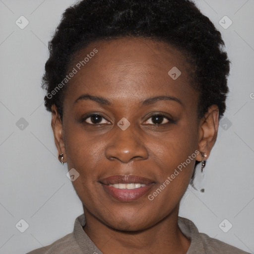 Joyful black young-adult female with short  brown hair and brown eyes