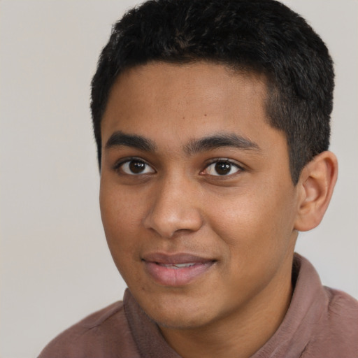 Joyful latino young-adult male with short  black hair and brown eyes
