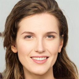 Joyful white young-adult female with long  brown hair and green eyes