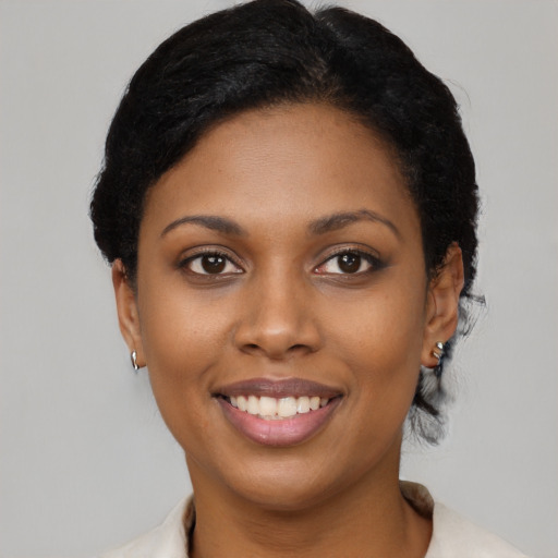 Joyful black young-adult female with medium  black hair and brown eyes