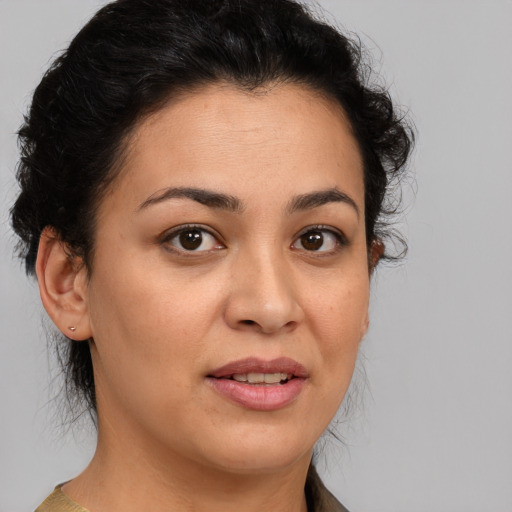 Joyful latino young-adult female with short  brown hair and brown eyes
