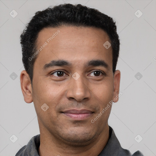 Joyful latino young-adult male with short  black hair and brown eyes