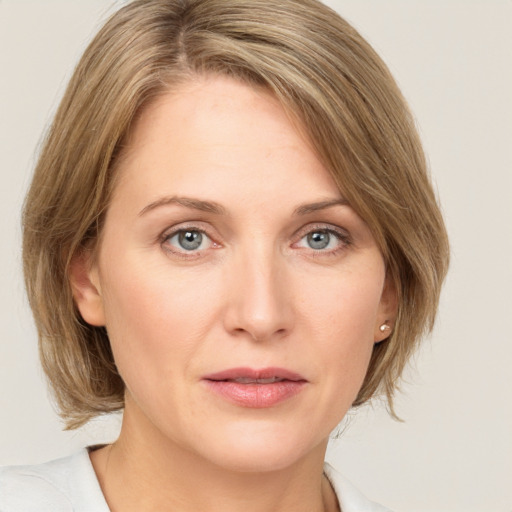 Joyful white young-adult female with medium  brown hair and green eyes