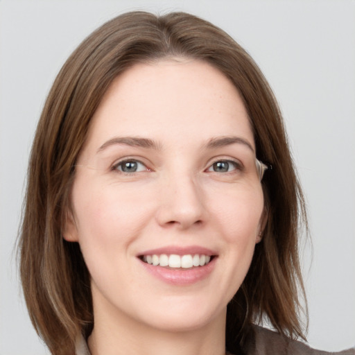 Joyful white young-adult female with medium  brown hair and grey eyes