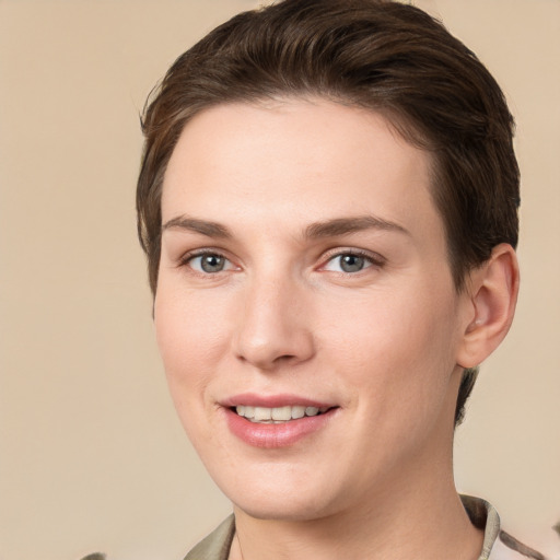 Joyful white young-adult female with short  brown hair and grey eyes