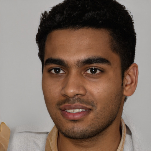 Joyful black young-adult male with short  black hair and brown eyes
