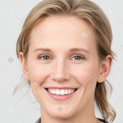 Joyful white young-adult female with medium  brown hair and blue eyes