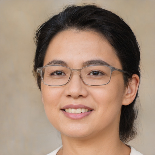 Joyful asian young-adult female with medium  brown hair and brown eyes