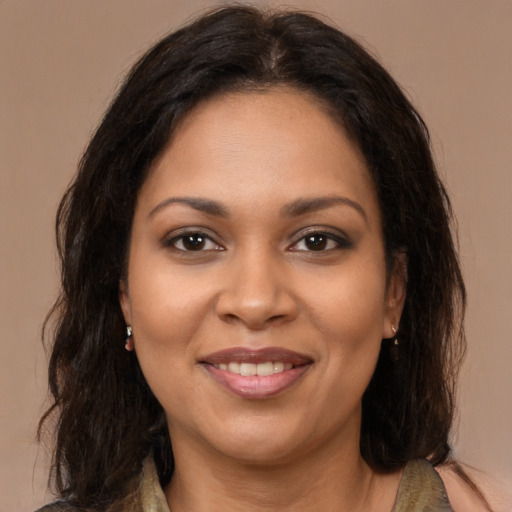 Joyful black young-adult female with medium  brown hair and brown eyes