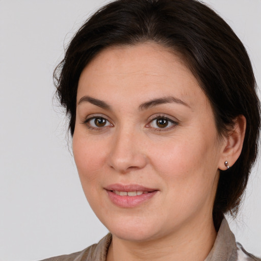 Joyful white young-adult female with medium  brown hair and brown eyes