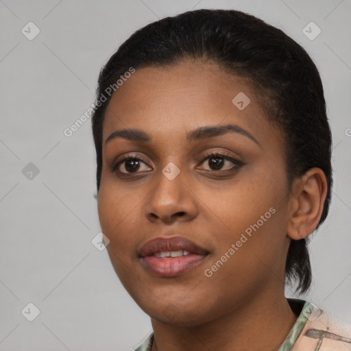 Joyful black young-adult female with short  black hair and brown eyes