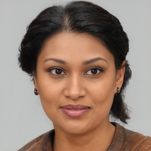 Joyful black young-adult female with medium  brown hair and brown eyes