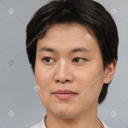 Joyful asian young-adult male with medium  brown hair and brown eyes