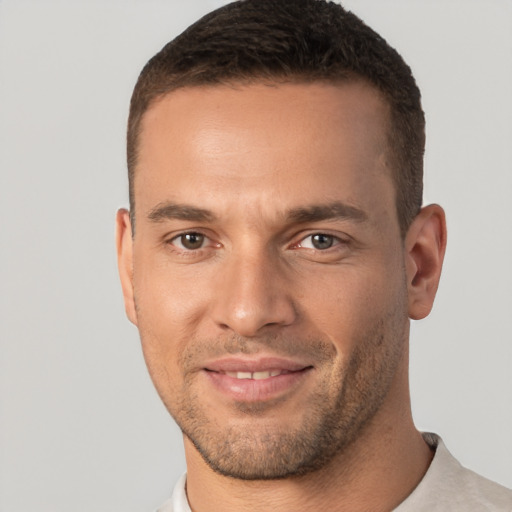 Joyful white young-adult male with short  brown hair and brown eyes