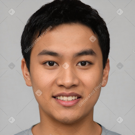 Joyful asian young-adult male with short  black hair and brown eyes