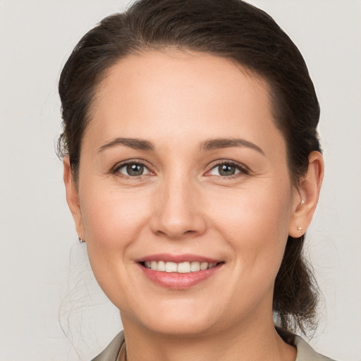 Joyful white young-adult female with medium  brown hair and brown eyes