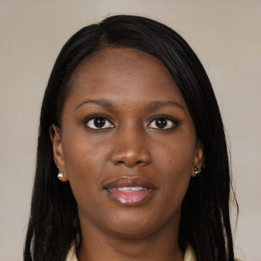 Joyful black young-adult female with long  black hair and brown eyes