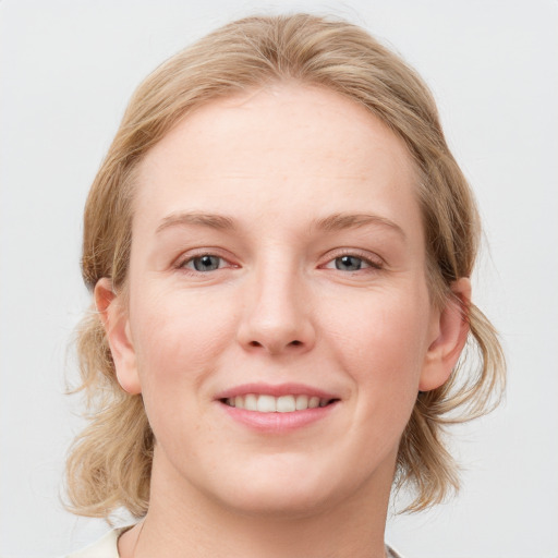 Joyful white young-adult female with medium  brown hair and blue eyes