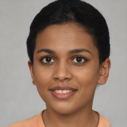 Joyful latino young-adult female with short  brown hair and brown eyes