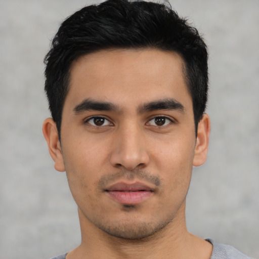 Neutral latino young-adult male with short  black hair and brown eyes