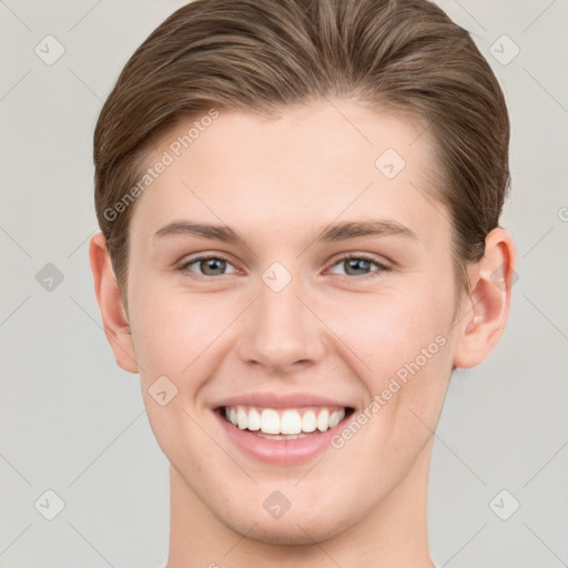 Joyful white young-adult female with short  brown hair and grey eyes