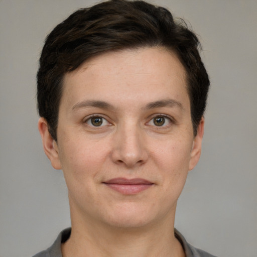 Joyful white young-adult female with short  brown hair and grey eyes