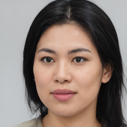 Joyful asian young-adult female with long  black hair and brown eyes