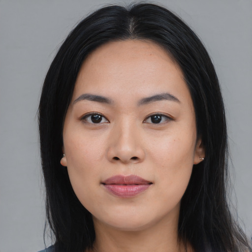 Joyful asian young-adult female with long  black hair and brown eyes