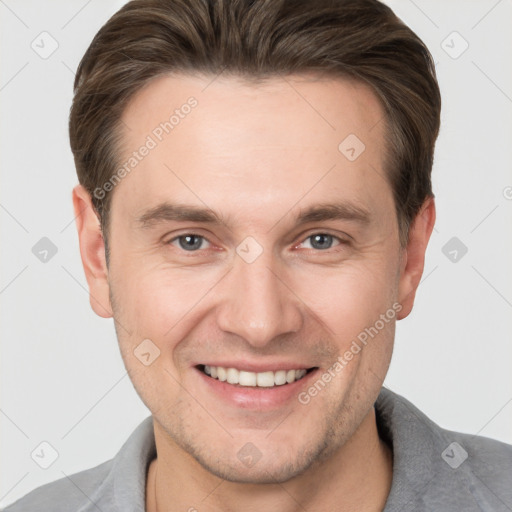 Joyful white adult male with short  brown hair and brown eyes