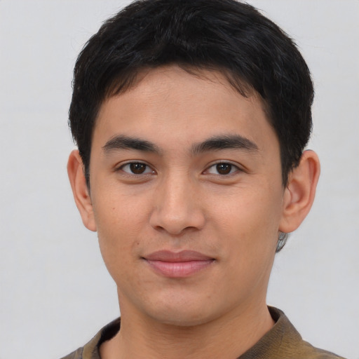Joyful asian young-adult male with short  brown hair and brown eyes