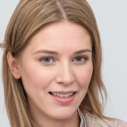 Joyful white young-adult female with long  brown hair and blue eyes