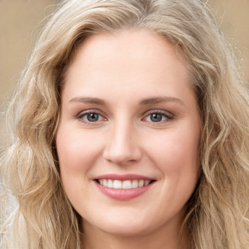 Joyful white young-adult female with long  brown hair and blue eyes