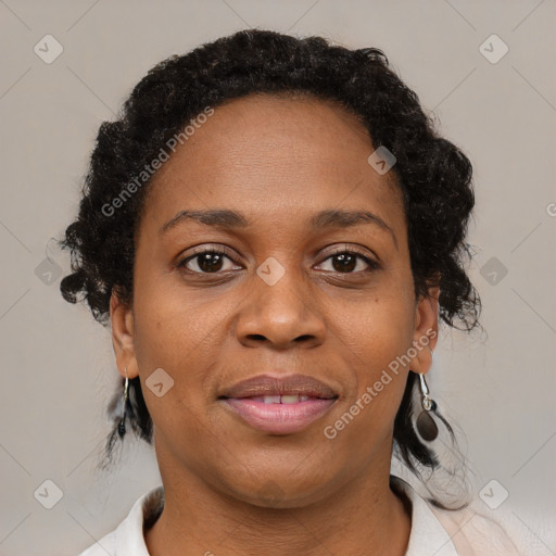 Joyful black adult female with medium  brown hair and brown eyes