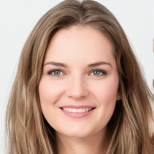 Joyful white young-adult female with long  brown hair and green eyes