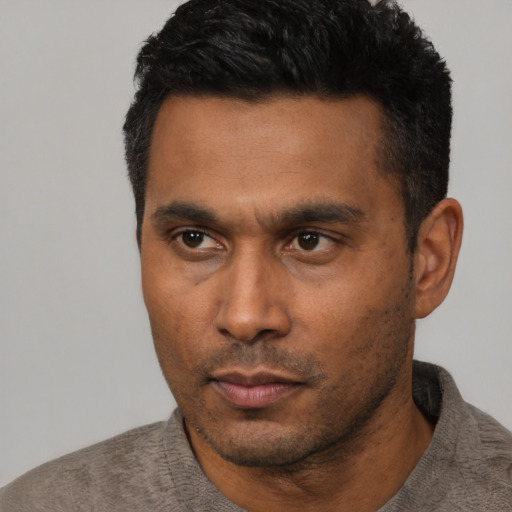 Neutral latino young-adult male with short  black hair and brown eyes