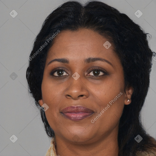 Joyful black adult female with long  black hair and brown eyes