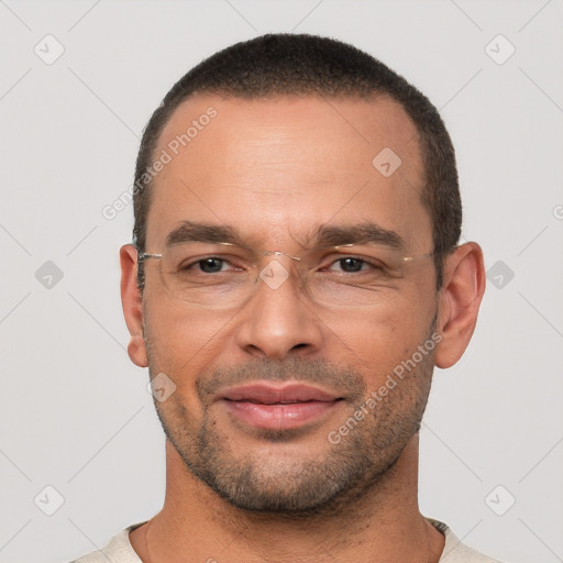 Joyful white adult male with short  brown hair and brown eyes