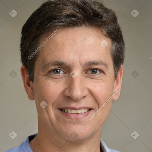 Joyful white adult male with short  brown hair and grey eyes