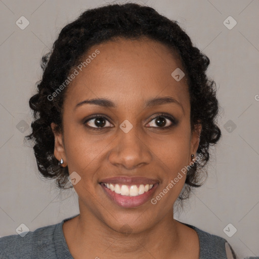 Joyful black young-adult female with long  brown hair and brown eyes