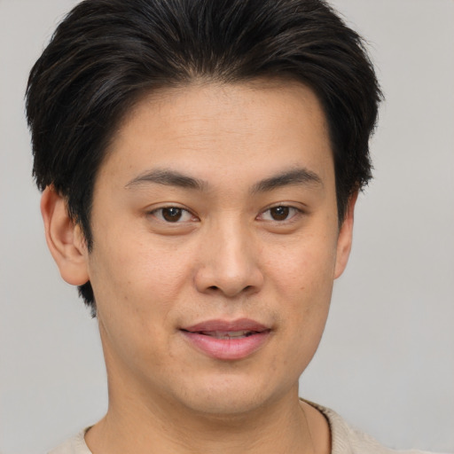 Joyful asian young-adult male with short  brown hair and brown eyes