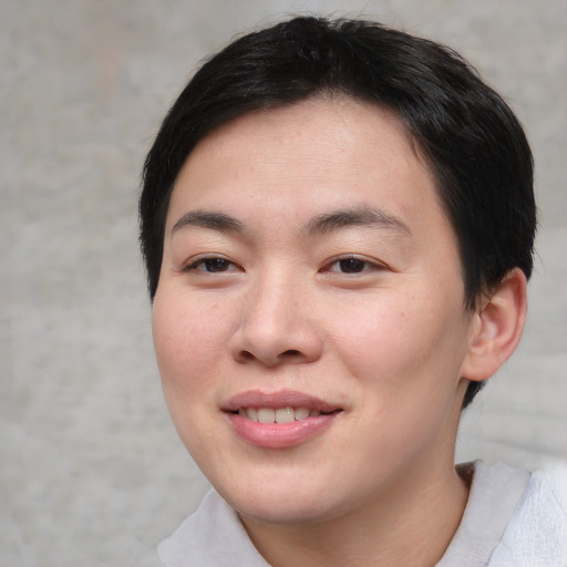 Joyful asian young-adult female with short  brown hair and brown eyes