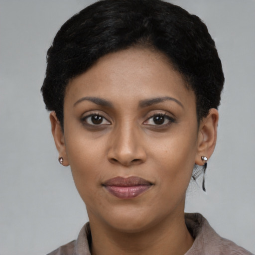 Joyful black young-adult female with short  black hair and brown eyes